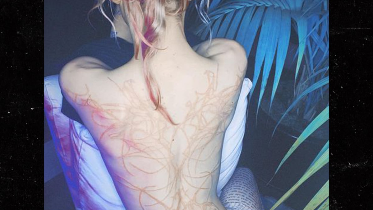 Grimes Shares Large Back Tattoo of 'Excellent Alien Scars'